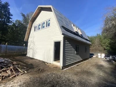 White and dark gray fiber cement siding on two-story residential home with new windows
