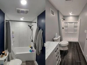 Bathroom with dark blue walls, white subway tile shower, vanity, and dark flooring