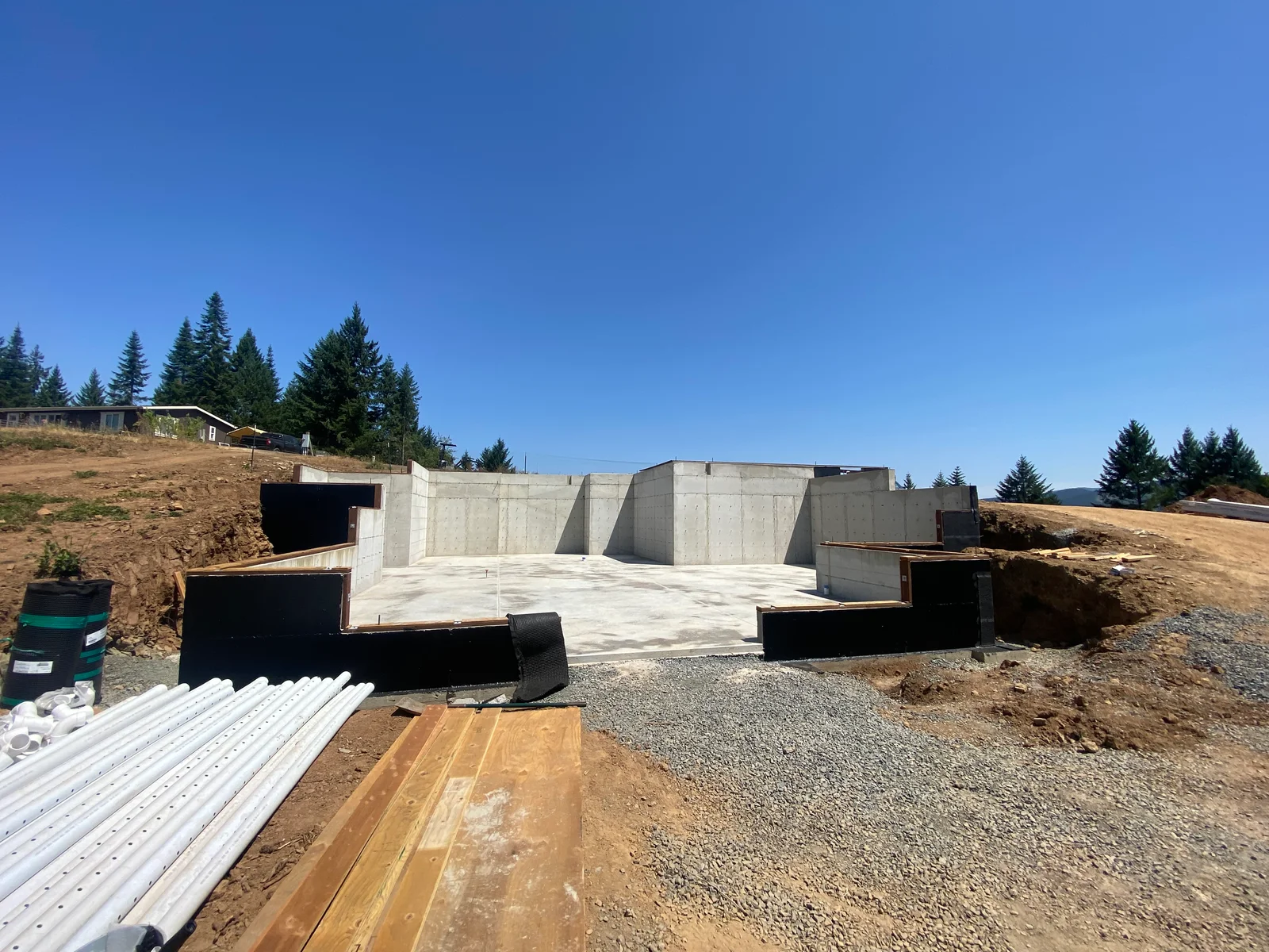 Concrete foundation walls and retaining structure with steel reinforcement on hillside construction site