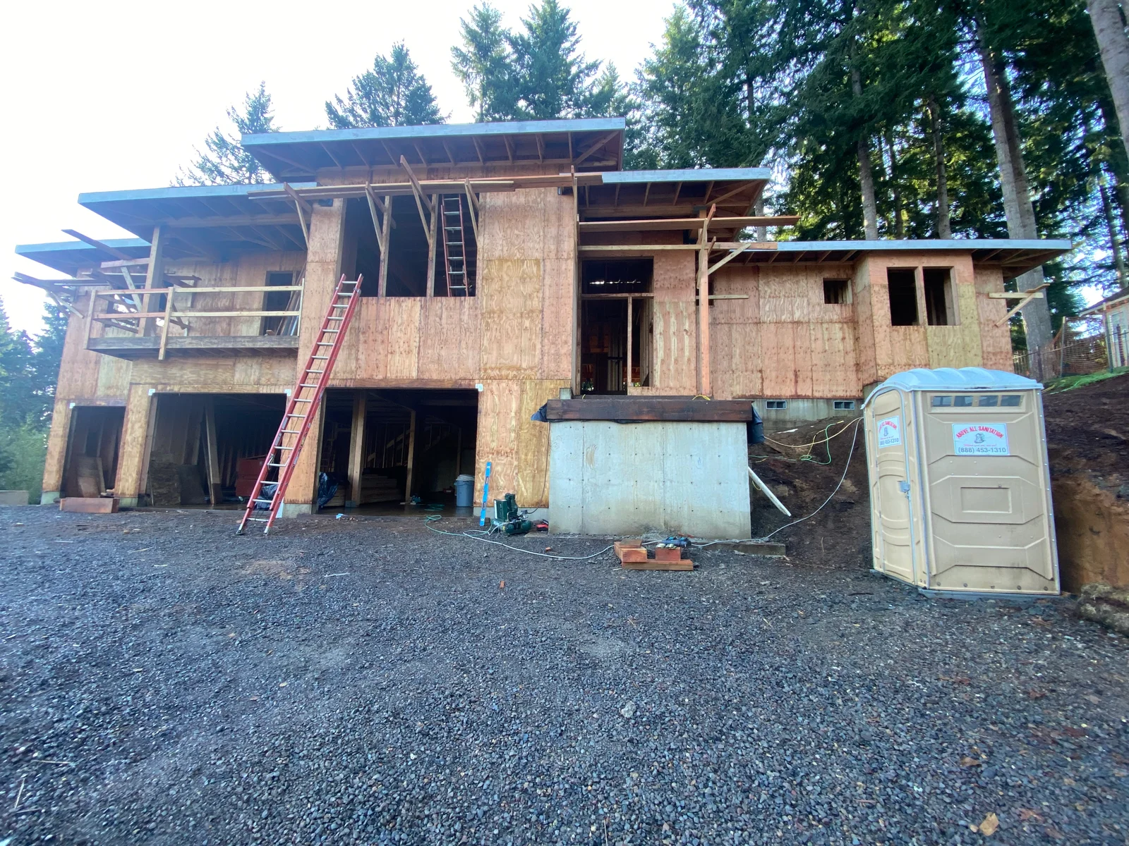Residential framing with OSB sheathing, metal roof panels, and structural lumber during construction